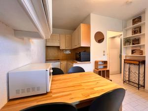 a kitchen with a table with a microwave on it at SeaNest Le Nid Marin in Saint-Raphaël