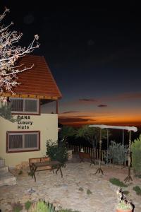 a building with a bench in front of it at Dana luxury huts in Dana