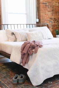 a bedroom with two beds and two shoes on the floor at East Main Your Merry Modern Downtown Getaway in Bowling Green +10 photos