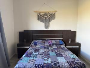 a bedroom with a bed with a quilt on it at Abril, alquiler temporario in Piñero +21 photos