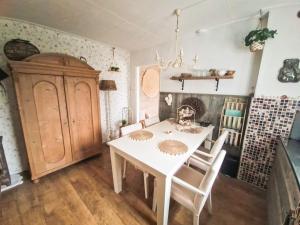a dining room with a white table and chairs at B&B Aan de Hoge Berg in Den Burg +13 photos