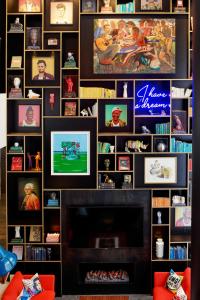 a living room with a fireplace and a wall of pictures at citizenM Washington DC Capitol in Washington, D.C.