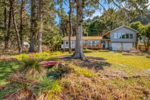 a house in the woods with a yard at Just Beachy 101 in Yachats