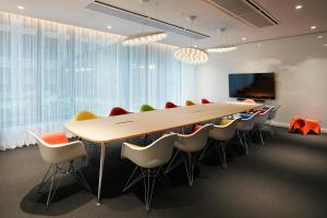 a conference room with a wooden table and chairs at citizenM Washington Capital in Washington
