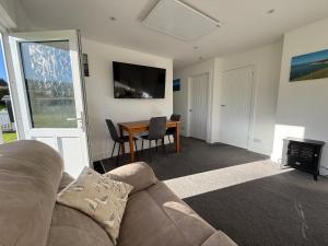 a living room with a couch and a table at Seagulls Rest in Isle of Wight