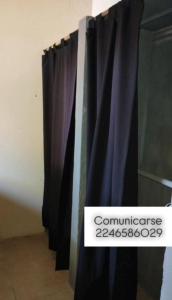 a black curtain with a sign that reads commnesia at Lumar in Santa Teresita
