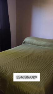 a close up of a bed with a sign on it at Lumar in Santa Teresita