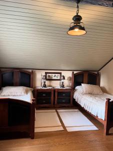 a bedroom with two beds and a lamp and a table at Villa Anna in Guta