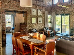 a living room with a wooden table and chairs at De Krantz 6 Estate in Clarens