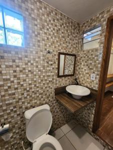 a bathroom with a toilet and a sink at Loft Iemanjá in Itacaré