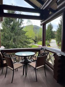a patio with a table and chairs on a porch at Villa Anna in Guta