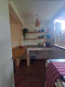 a kitchen with a table and a sink in it at Loft Iemanjá in Itacaré +3 photos
