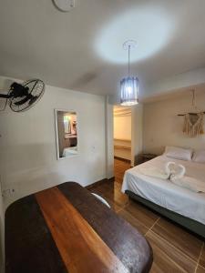 a bedroom with a large bed and a mirror at Loft Iemanjá in Itacaré