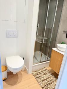 a bathroom with a shower and a toilet and a sink at Residentie Nieuwpoort in Nieuwpoort +8 photos