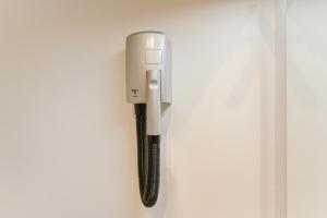 a wall mounted phone hanging on a wall at Luminosa stanza 4 bagno privato vicino Stazione in Padova