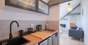 a kitchen with a sink and a counter top at Le Perchoir du marché - Appartement pour 2 personnes in Saint-Nazaire +4 photos