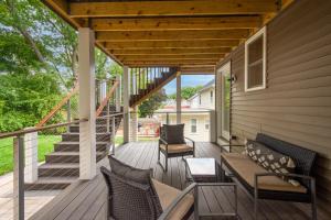 a porch with chairs and a couch on a house at 2BR DOG-Friendly Apt in 2-Fam Home - Comfy Retreat in Boston