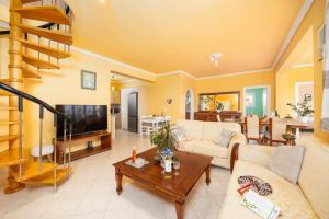 a living room with a couch and a tv at Villa Spartera in Sparterá