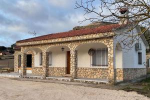 a small stone building with a red roof at Casa Rural Las Matillas in Riópar