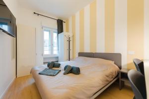 a bedroom with a bed with two pillows on it at BonB 127 c7-c8 in Padova