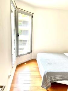 Ένα ή περισσότερα κρεβάτια σε δωμάτιο στο Depto Alassio 2 ambiente con parilla