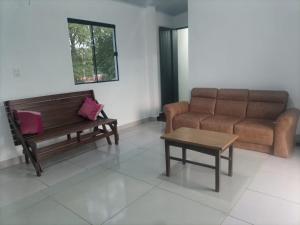 a living room with a couch and a coffee table at Refugio Ruth Nahomi in Encarnación