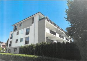 a white building with a fence in front of it at SeePERLE 131 in Friedrichshafen