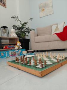a chessboard on a table in a living room at S&M Cozy Garden Lagonisi in Lagonissi