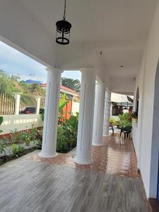 an empty hallway of a house with white columns at Luxury Posada inn in Los Amates