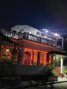a large house with a balcony at night at Luxury Posada inn in Los Amates