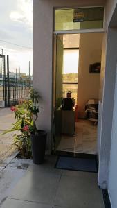 an open door of a building with a potted plant at Barcel Flat in Teresina