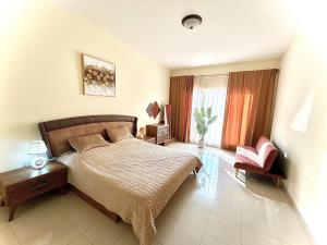 a bedroom with a bed and a chair at Bab Al Bahr 2 BR Apartment in Ras al Khaimah +17 photos