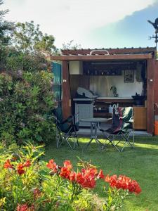 a patio with a table and chairs in a yard at Dover Terrace in Kaikoura