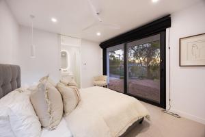 a bedroom with a bed and a large window at Grandview Lookout - McCrae in McCrae