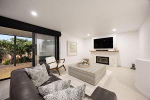 a living room with a couch and a fireplace at Grandview Lookout - McCrae in McCrae