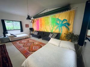 a room with a bed and a painting on the wall at Bellingen Disco Studio in Gleniffer