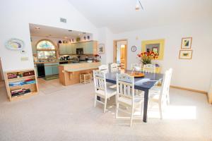 a kitchen and dining room with a table and chairs at Soundside-Resort Amenities, Comm Pool-322, Out of Bounds in Corolla