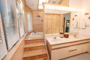 a bathroom with a sink and a mirror at Soundside-Resort Amenities, Comm Pool-322, Out of Bounds in Corolla +32 photos