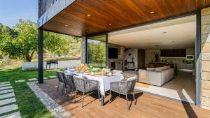 a patio with a table and chairs on a deck at Quinta da Lameirinha Douro, Boutique Home in Baião