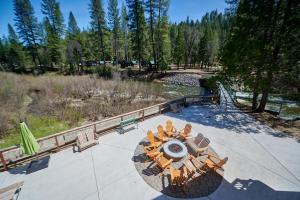 een bovenaanzicht van een terras met stoelen en een tafel bij Yosemite Lakes Bunkhouse Cabin 27 in Harden Flat