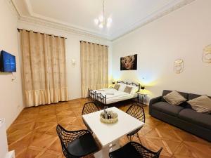a living room with a couch and a table and chairs at Zitna Downtown Residence in Prague