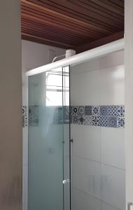 una ducha con puerta de cristal en un baño en Apartamento Moderno com vista para á principal, en Volta Redonda 8 fotos más