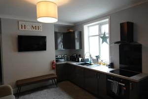 a kitchen with a counter and a sink and a window at Victorian Suites - Spacious 2 Bed Apartment in Southport