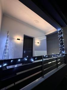 a room with a fence with lights and a christmas tree at BelAir Luxury Living - 'The One Villa' in Kardítsa
