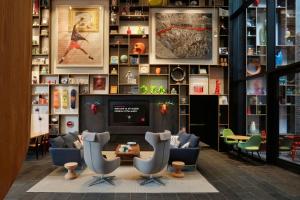 a lobby with couches and a tv in a store at citizenM New York Bowery in New York