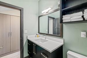 a bathroom with a sink and a mirror at Bear Claw 405 - Luxury Condo, Ski-in Ski-out Access, Slope Views & Winter Shuttle! in Steamboat Springs +22 photos