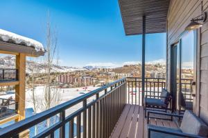 a balcony with a view of the snow covered mountains at Bear Claw 405 - Luxury Condo, Ski-in Ski-out Access, Slope Views & Winter Shuttle! in Steamboat Springs