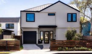 a white house with a black garage at Central Austin Oasis with Pool - Sleeps 9 in Austin