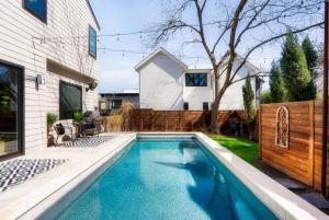 a swimming pool in the backyard of a house at Central Austin Oasis with Pool - Sleeps 9 in Austin