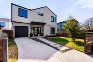 a house with a driveway in front of it at Central Austin Oasis with Pool - Sleeps 9 in Austin